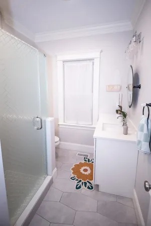 a bathroom with a sink toilet and shower