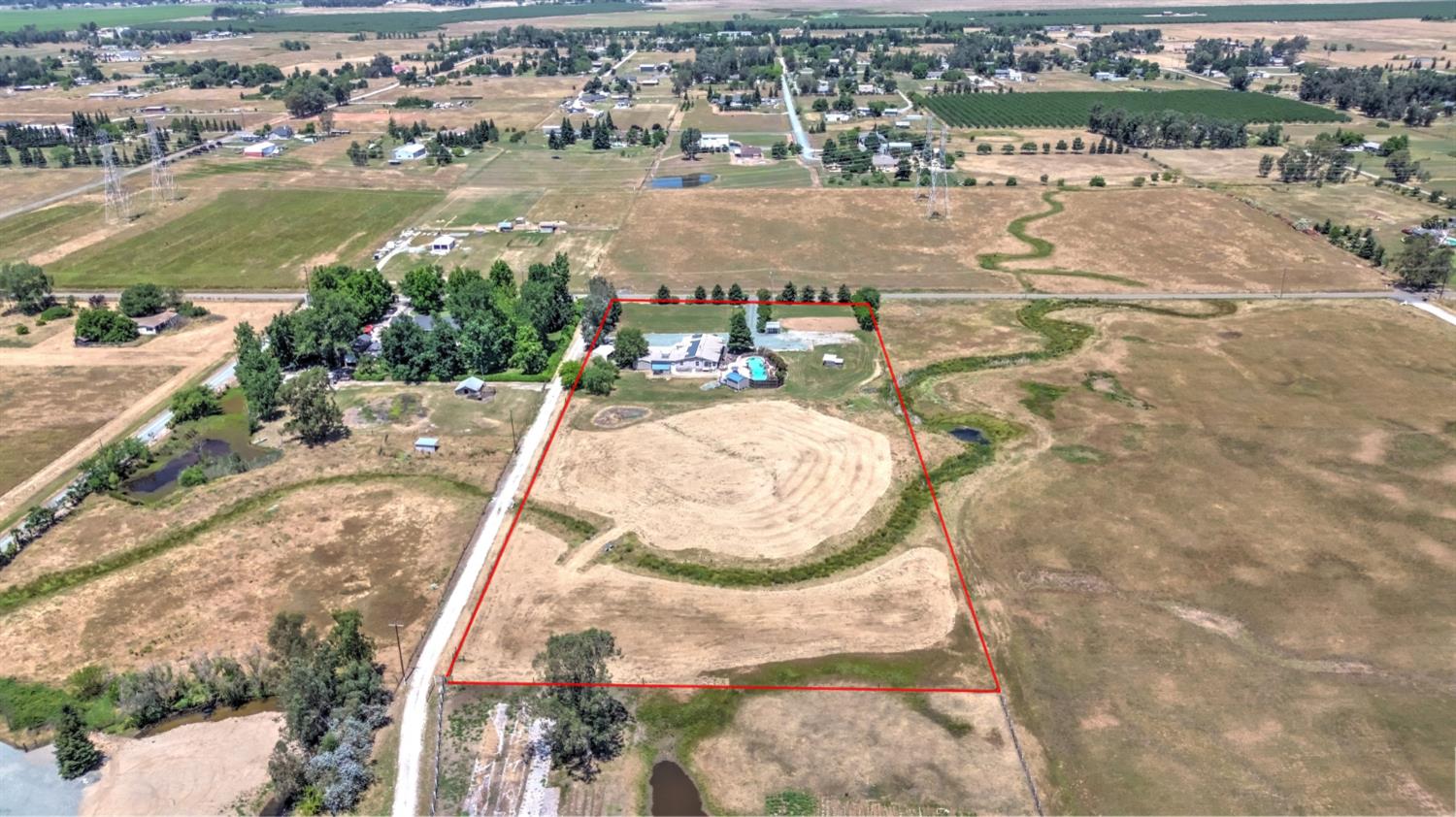12390 Hobday Road Wilton, CA 95693 - Photo 85 of 92 an aerial view of a house with a yard and lake view in back