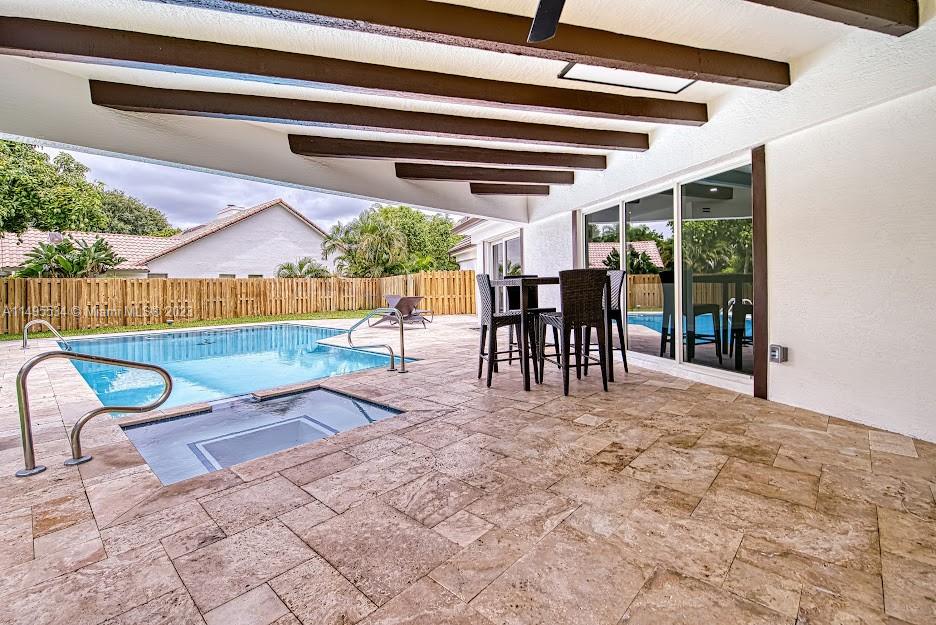 3010 Equestrian Drive Boca Raton, FL 33434 - Photo 13 of 53 a view of a chairs and table in patio with a backyard