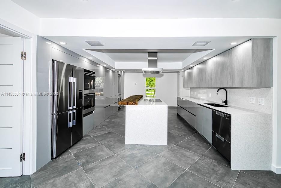 3010 Equestrian Drive Boca Raton, FL 33434 - Photo 16 of 53 a kitchen with a refrigerator and a sink