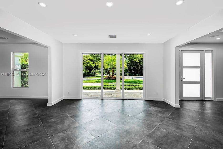 3010 Equestrian Drive Boca Raton, FL 33434 - Photo 23 of 53 a view of an empty room with wooden floor and a window