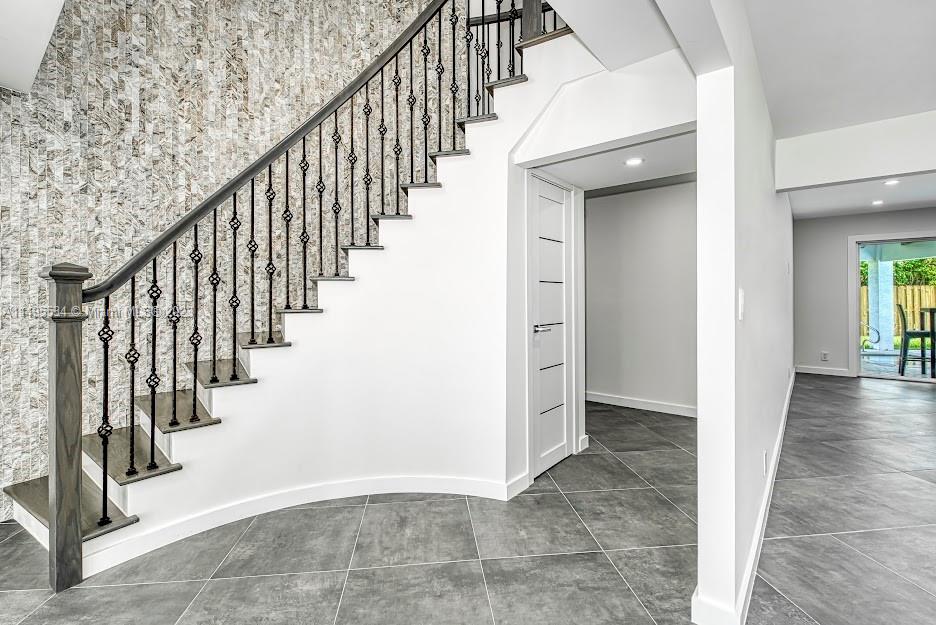 3010 Equestrian Drive Boca Raton, FL 33434 - Photo 25 of 53 a view of an entryway with wooden floor and stairs