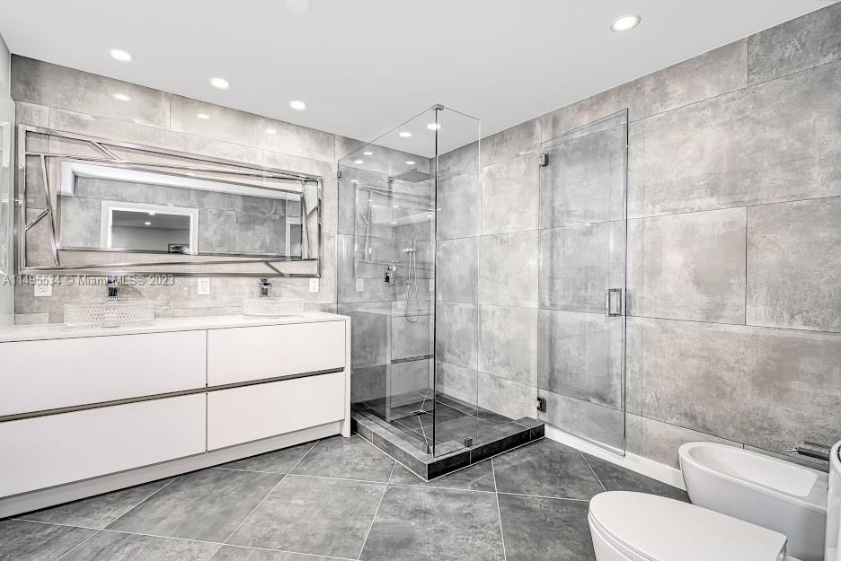 3010 Equestrian Drive Boca Raton, FL 33434 - Photo 31 of 53 a bathroom with a toilet a sink and mirror