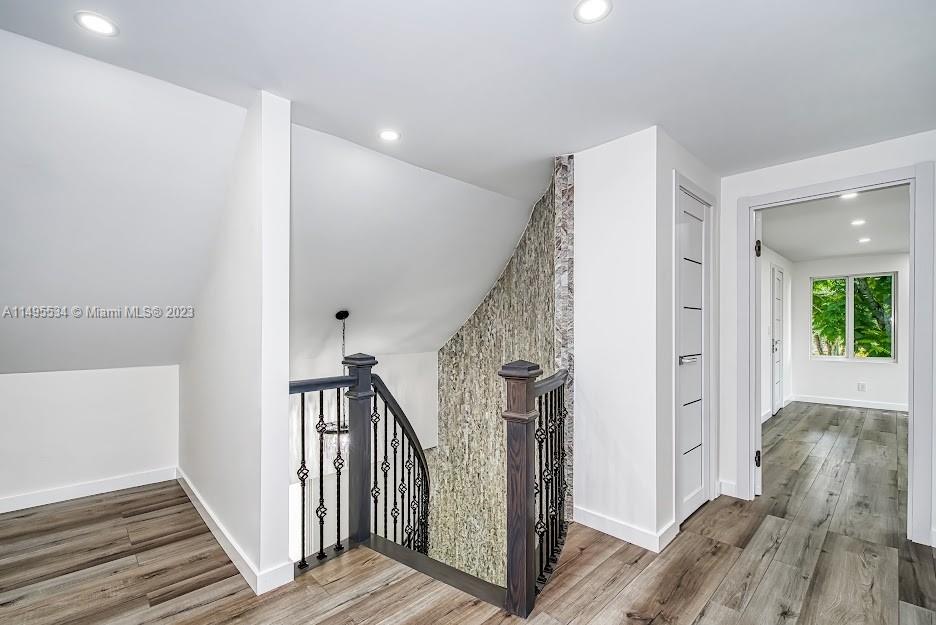 3010 Equestrian Drive Boca Raton, FL 33434 - Photo 37 of 53 a view of a hallway with wooden floor and staircase