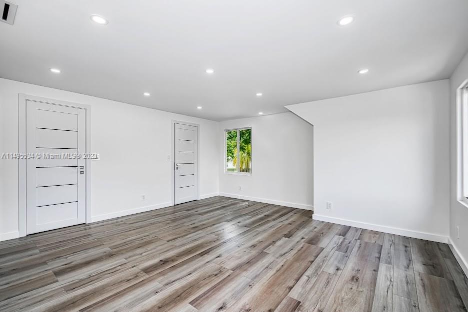 3010 Equestrian Drive Boca Raton, FL 33434 - Photo 40 of 53 a view of an empty room with wooden floor and closet
