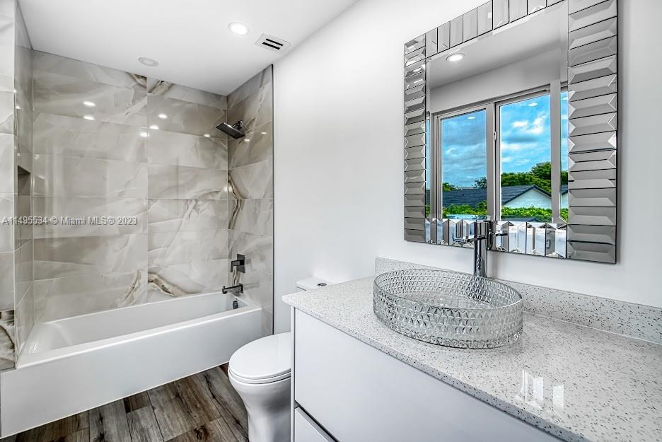 3010 Equestrian Drive Boca Raton, FL 33434 - Photo 41 of 53 a bath room with a toilet and a bath tub