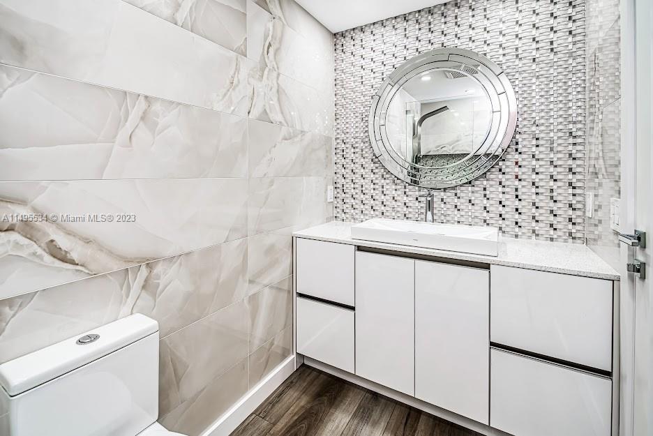 3010 Equestrian Drive Boca Raton, FL 33434 - Photo 44 of 53 a bathroom with a sink and mirror