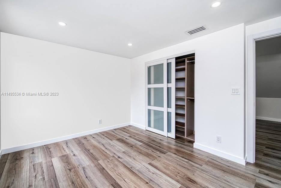 3010 Equestrian Drive Boca Raton, FL 33434 - Photo 47 of 53 a view of wooden floor and windows in a room