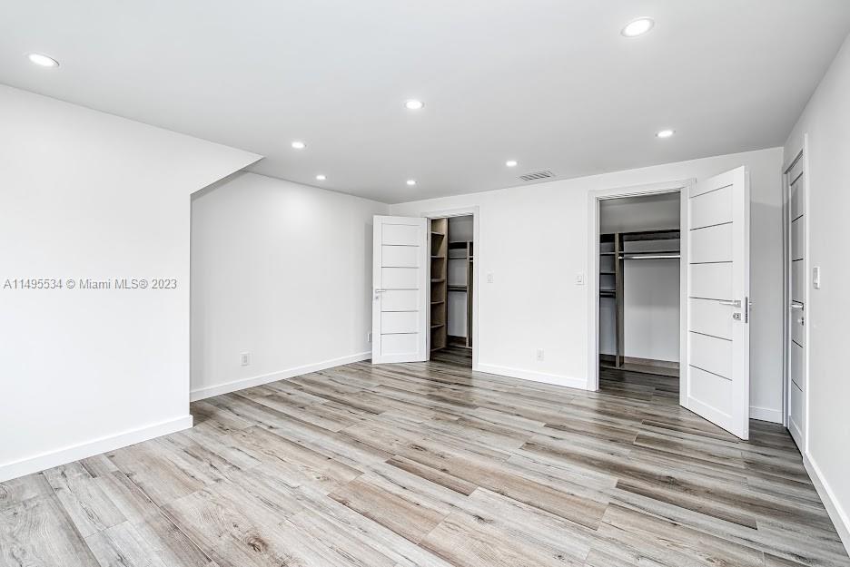 3010 Equestrian Drive Boca Raton, FL 33434 - Photo 49 of 53 a view of an empty room with wooden floor