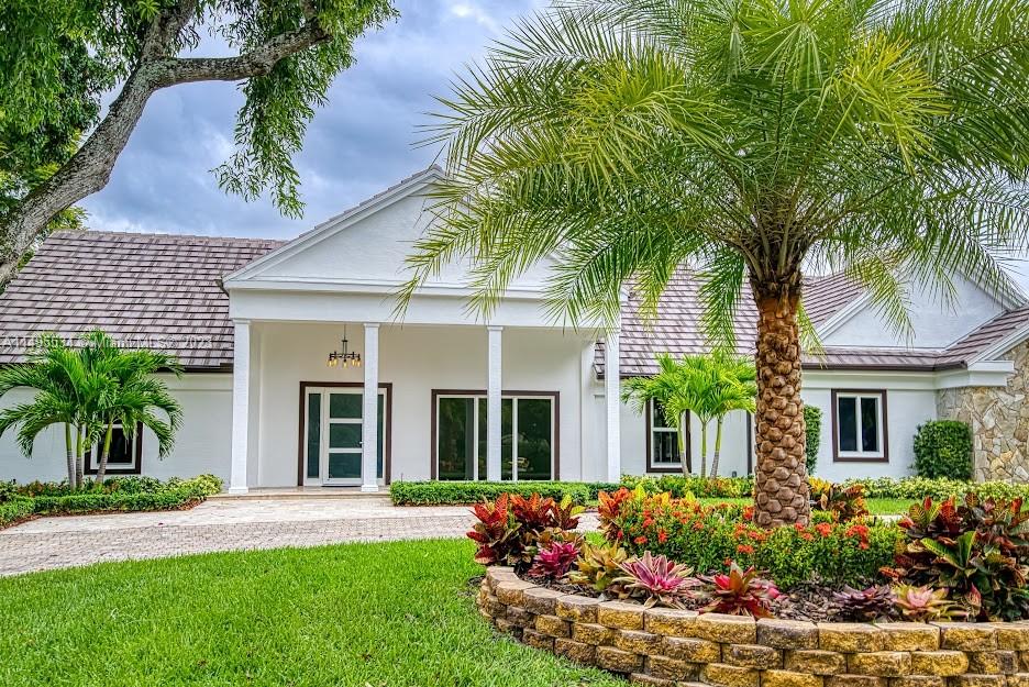 3010 Equestrian Drive Boca Raton, FL 33434 - Photo 5 of 53 front view of a house with a yard