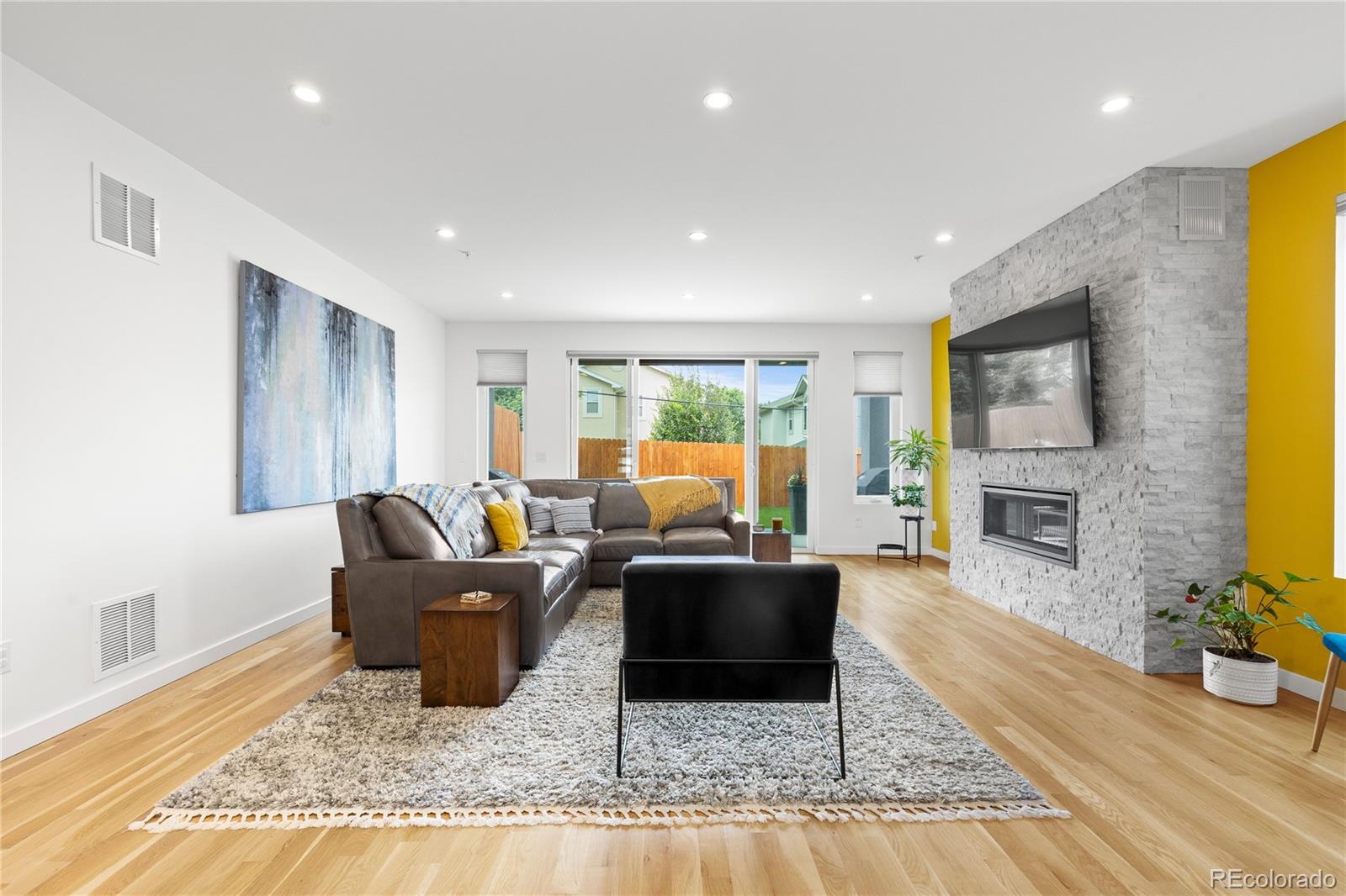 5327 Raleigh Street Denver, CO 80212 - Photo 17 of 40 a living room with furniture and a fireplace