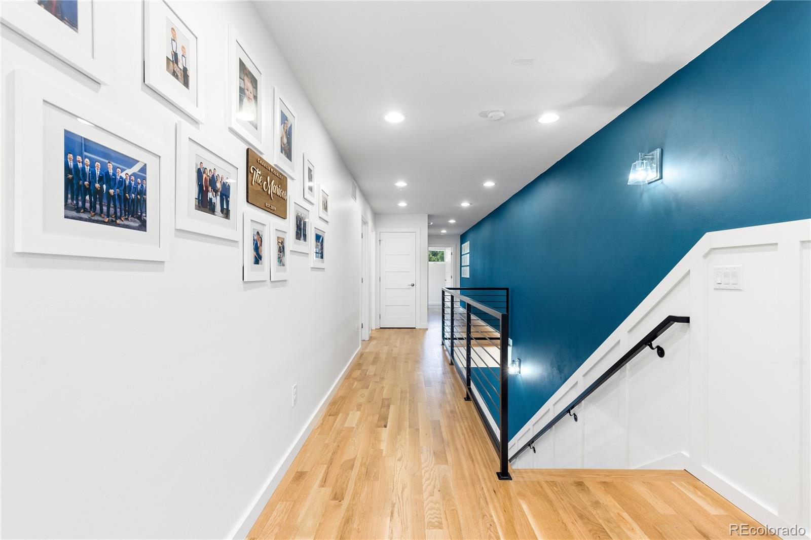 5327 Raleigh Street Denver, CO 80212 - Photo 19 of 40 a view of a hallway with wooden floor and staircase
