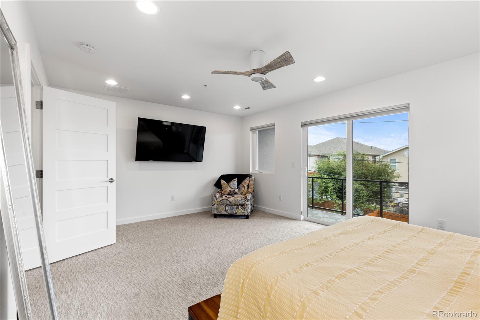 5327 Raleigh Street Denver, CO 80212 - Photo 22 of 40 a room with a bed tv and a large window