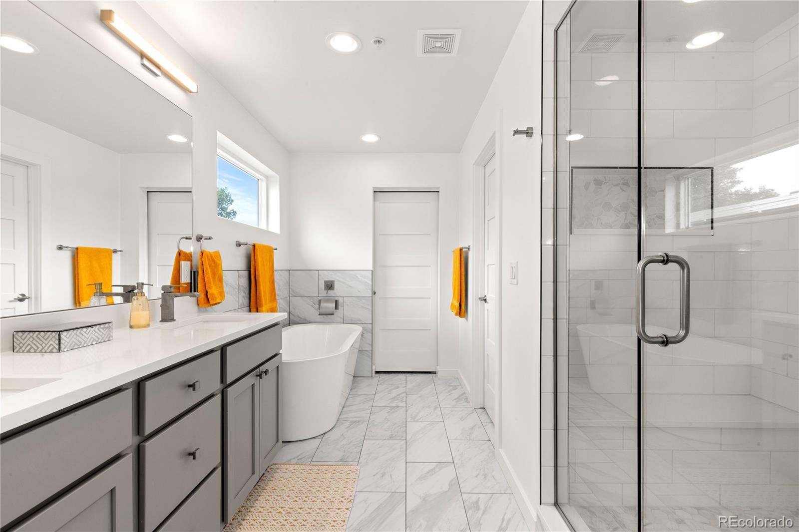 5327 Raleigh Street Denver, CO 80212 - Photo 25 of 40 a bathroom with a sink double vanity mirror and a shower