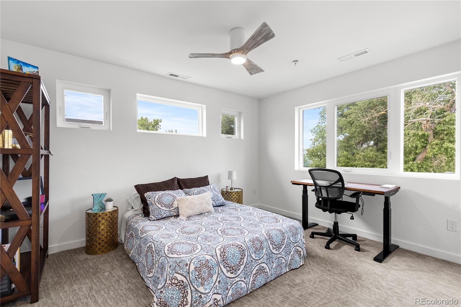 5327 Raleigh Street Denver, CO 80212 - Photo 26 of 40 a bedroom with a bed a computer on the desk and a large window