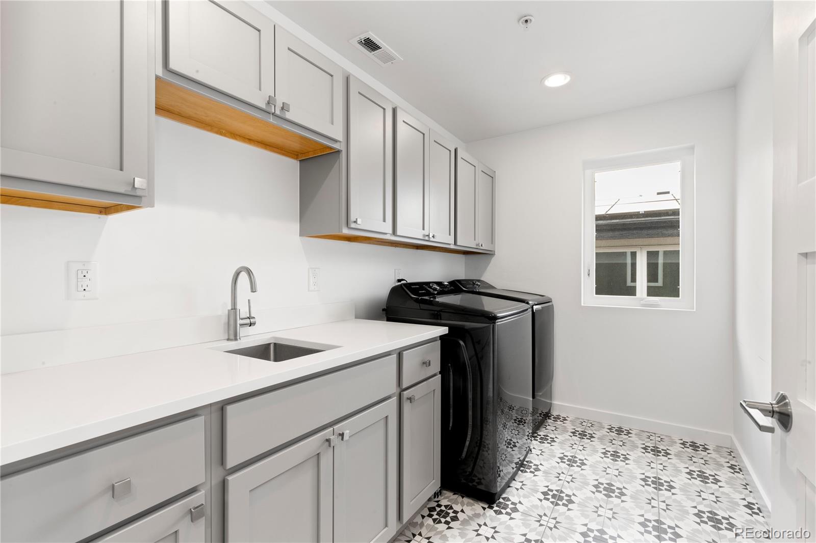 5327 Raleigh Street Denver, CO 80212 - Photo 29 of 40 a kitchen with a sink and cabinets