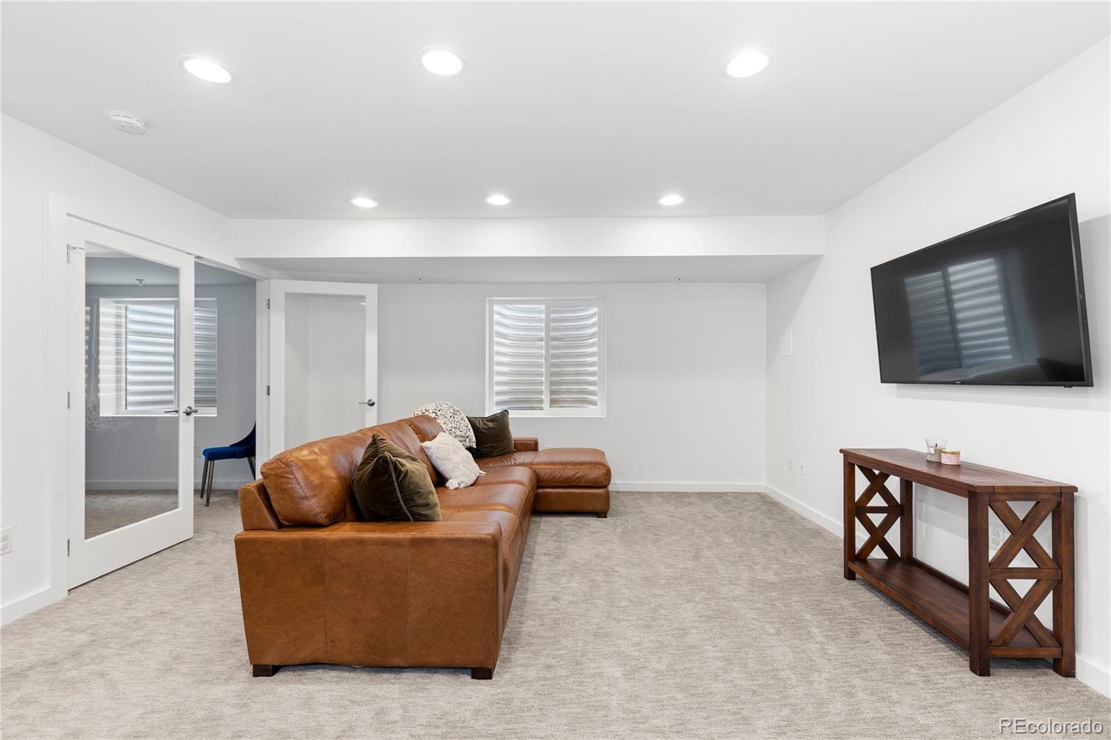 5327 Raleigh Street Denver, CO 80212 - Photo 30 of 40 a living room with furniture and a flat screen tv