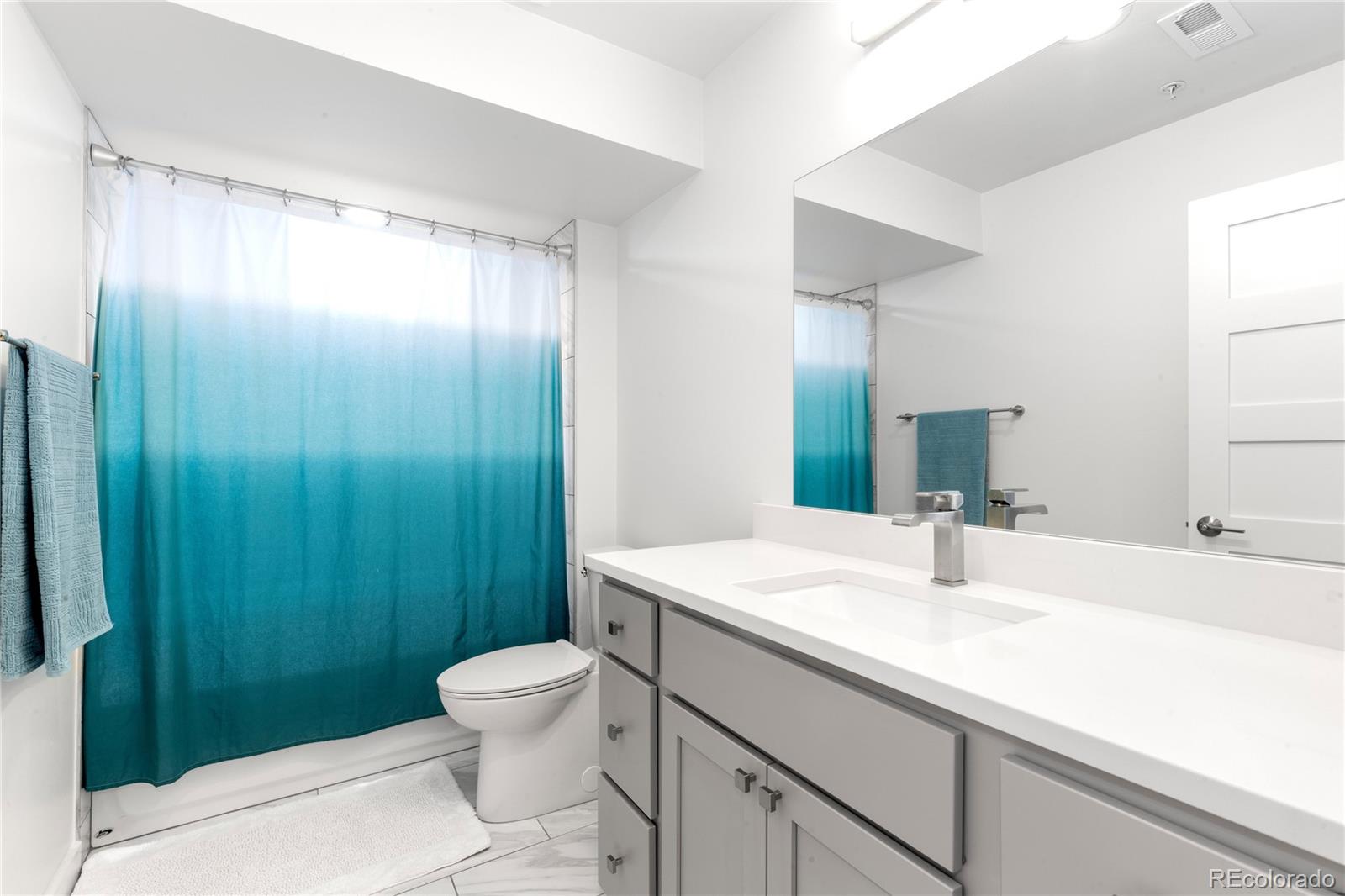 5327 Raleigh Street Denver, CO 80212 - Photo 34 of 40 a bathroom with a sink a toilet and shower