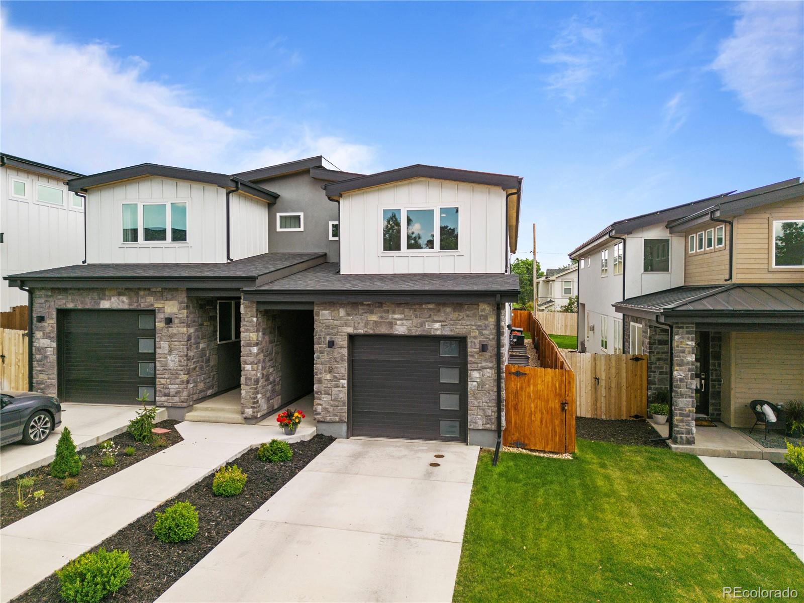 5327 Raleigh Street Denver, CO 80212 - Photo 39 of 40 a front view of a house with a yard and garage