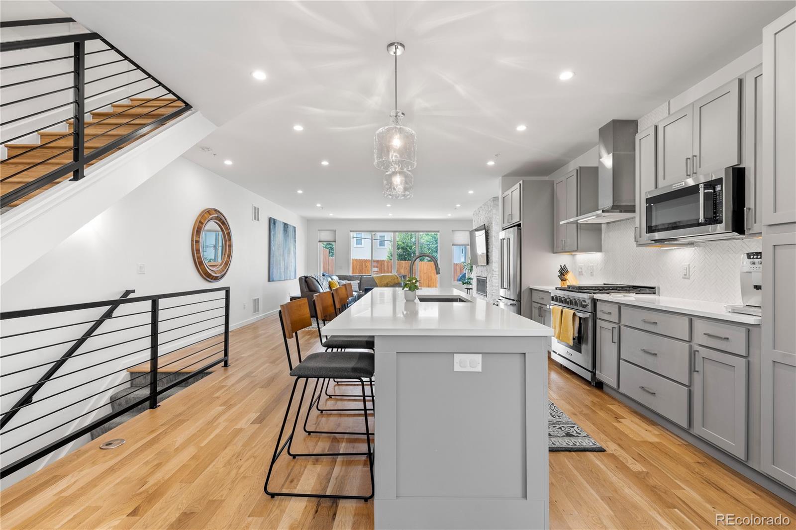 5327 Raleigh Street Denver, CO 80212 - Photo 7 of 40 a kitchen with stainless steel appliances granite countertop a stove and a sink