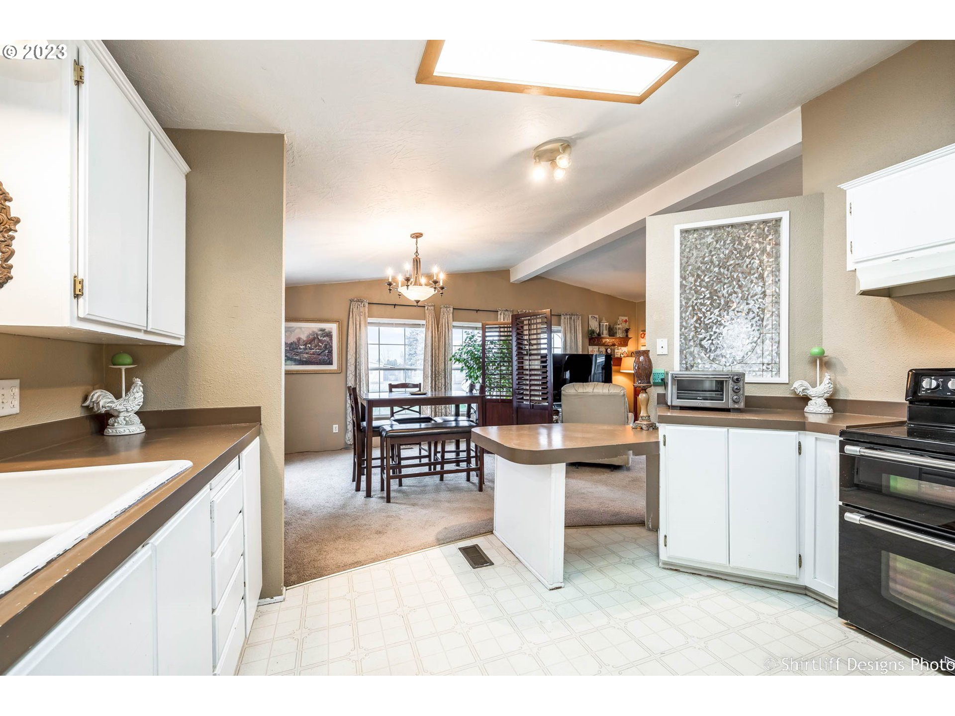 1699 North Terry Street, Unit 164 Eugene, OR 97402 - Photo 15 of 31 a kitchen with stainless steel appliances kitchen island granite countertop a sink and cabinets