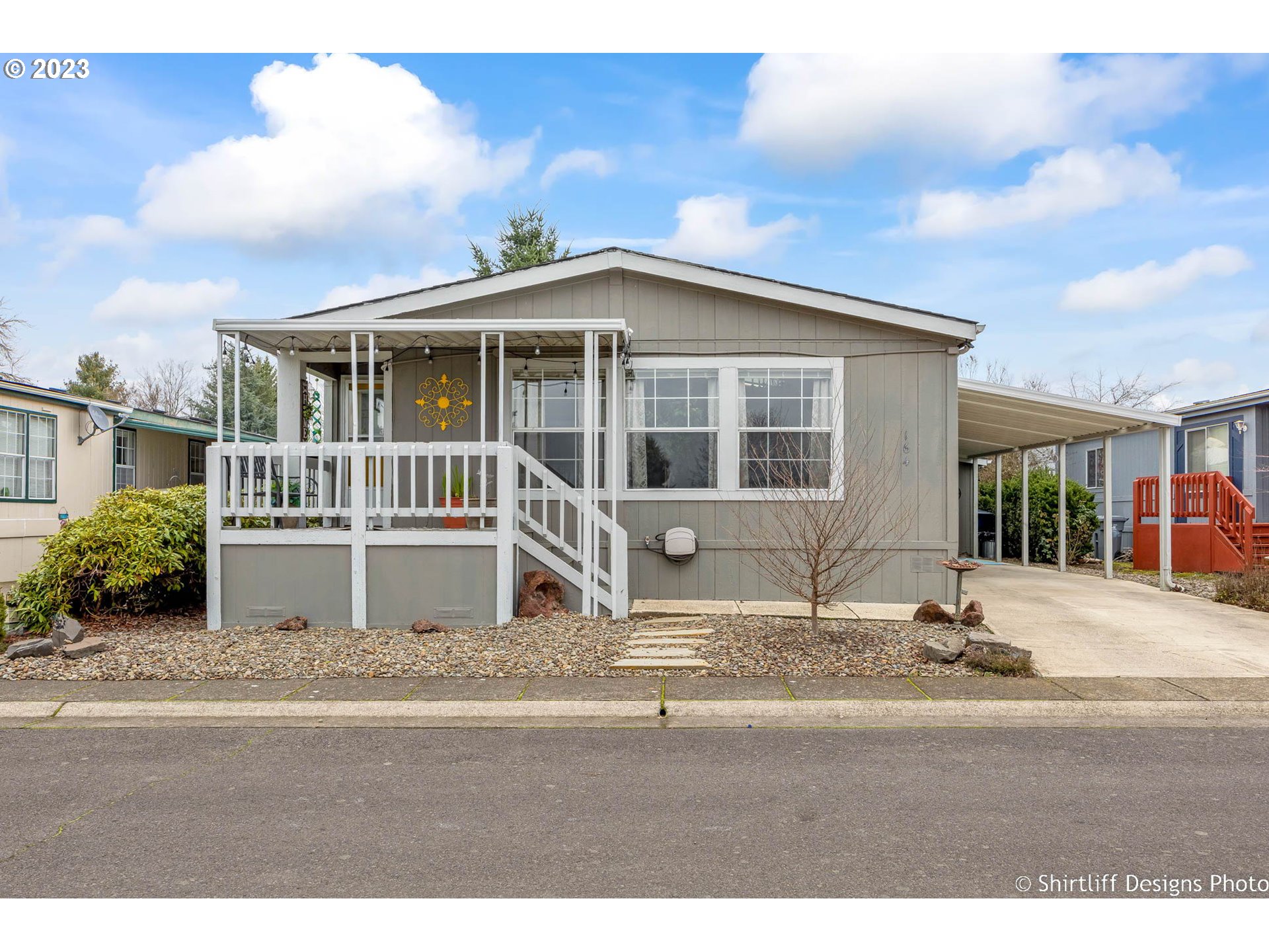 1699 North Terry Street, Unit 164 Eugene, OR 97402 - Photo 2 of 31 a front view of a house with a garden