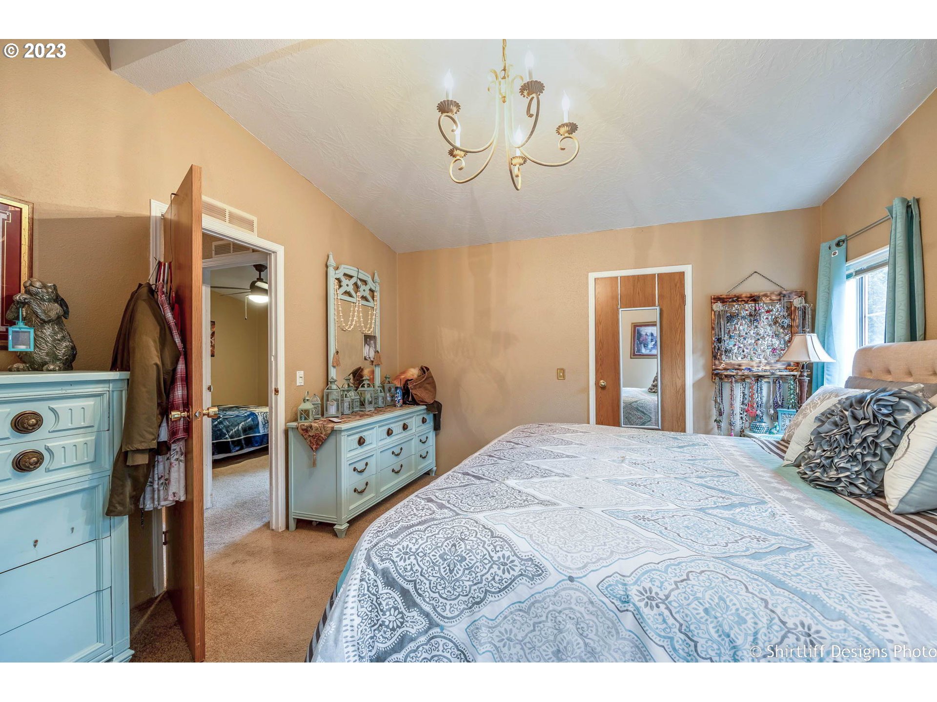1699 North Terry Street, Unit 164 Eugene, OR 97402 - Photo 23 of 31 a bedroom with a bed and a dresser in it