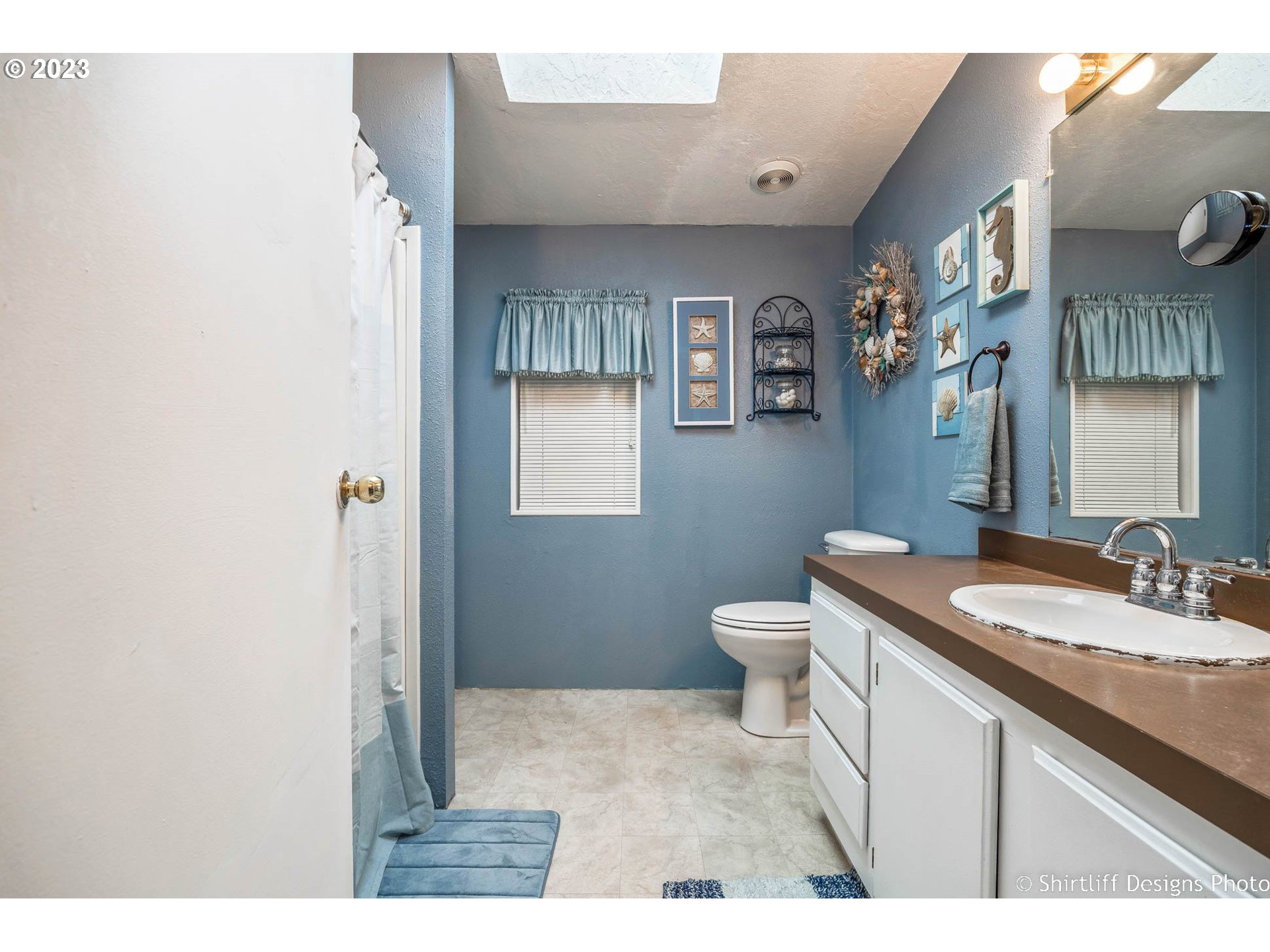 1699 North Terry Street, Unit 164 Eugene, OR 97402 - Photo 24 of 31 a bathroom with a granite countertop sink toilet and mirror