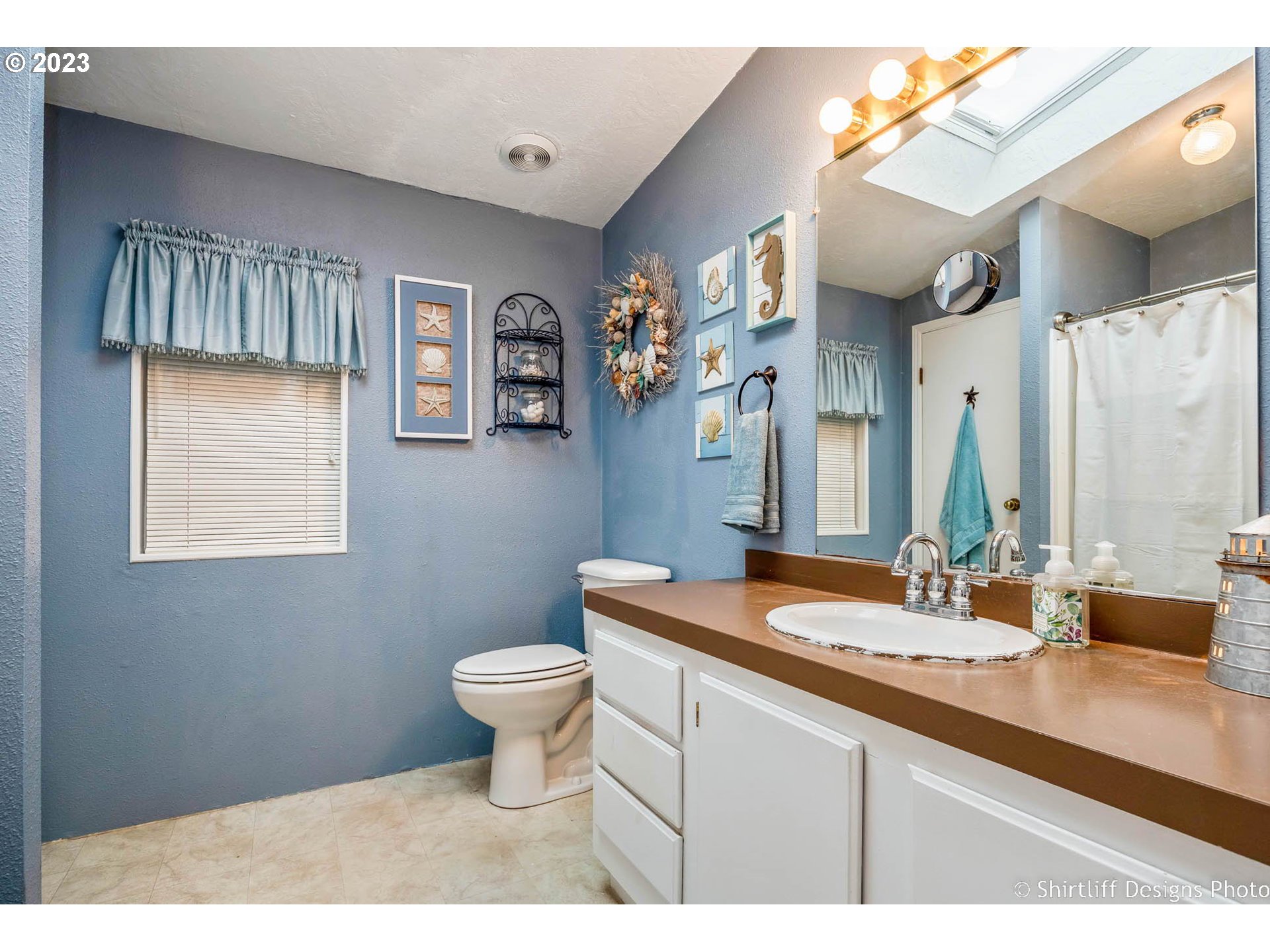 1699 North Terry Street, Unit 164 Eugene, OR 97402 - Photo 25 of 31 a bathroom with a sink a toilet and mirror