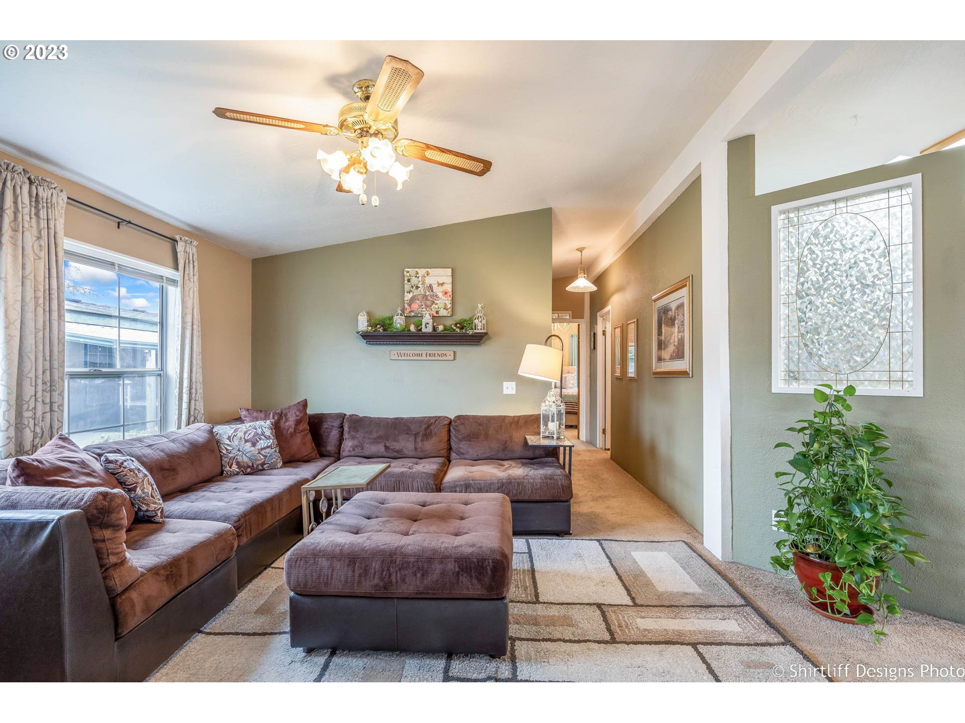 1699 North Terry Street, Unit 164 Eugene, OR 97402 - Photo 7 of 31 a living room with furniture and a chandelier