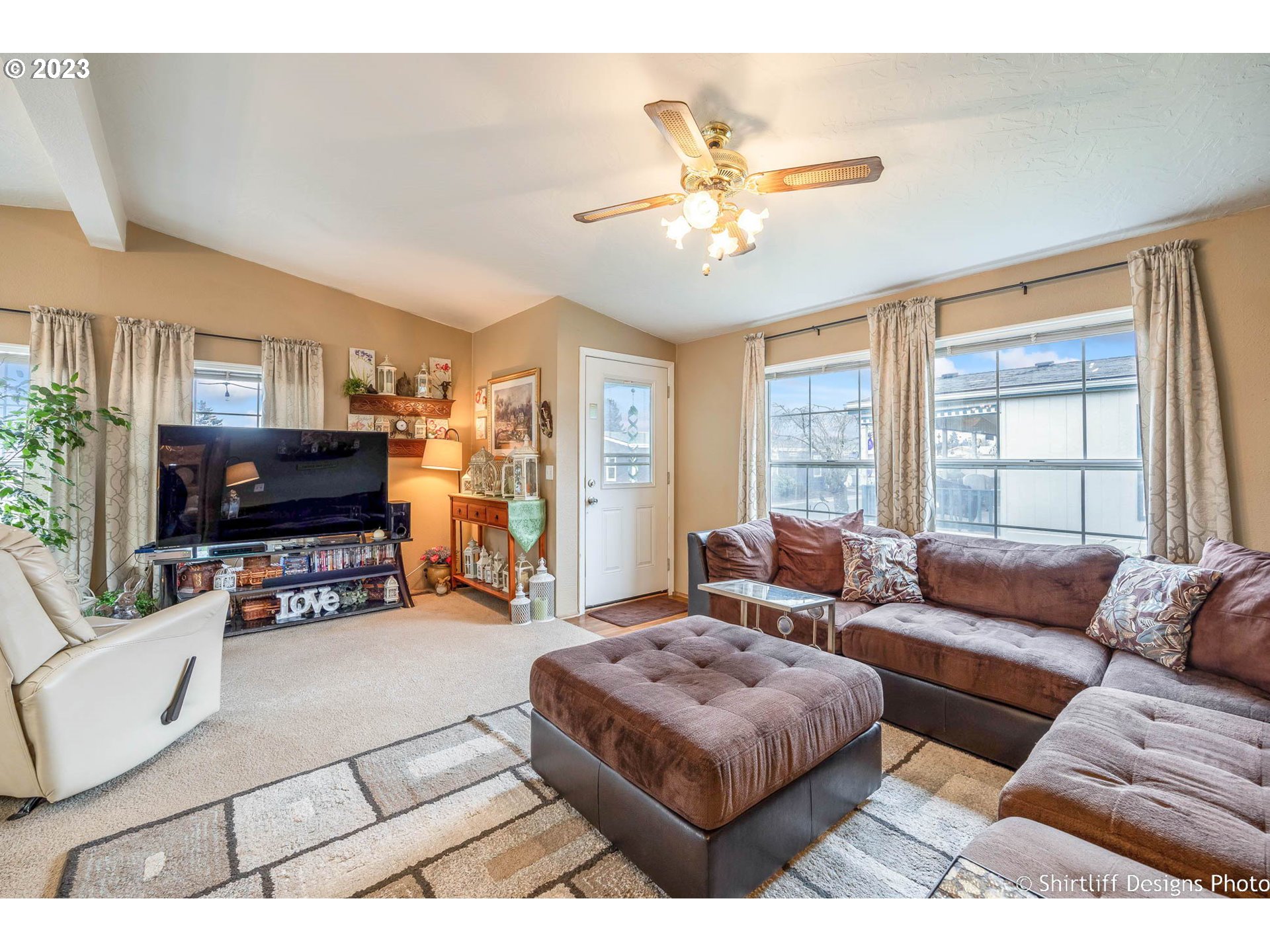 1699 North Terry Street, Unit 164 Eugene, OR 97402 - Photo 9 of 31 a living room with furniture and a flat screen tv