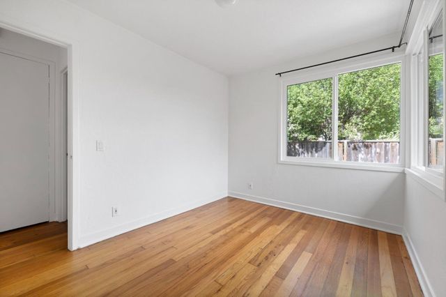 a bathroom with a sink vanity granite toilet and a mirror