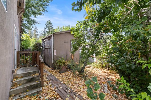 an aerial view of residential houses with outdoor space and trees