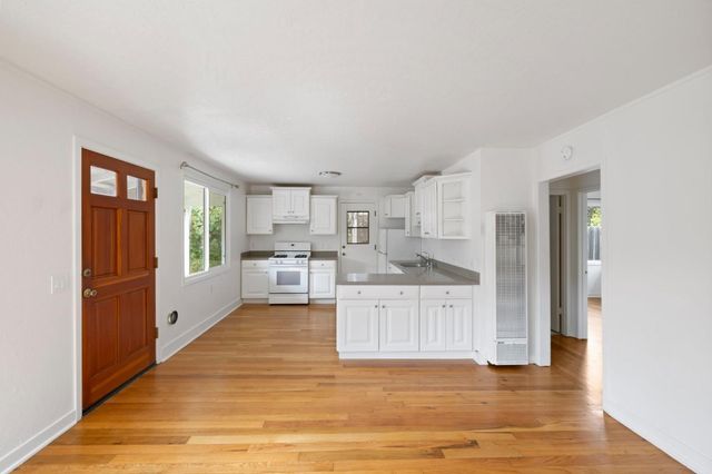 a white stove top oven sitting inside of a kitchen