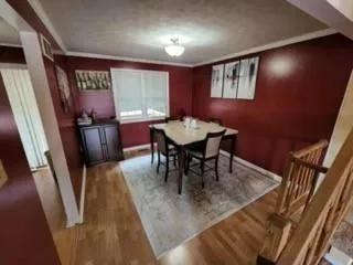 a dining room with furniture and window
