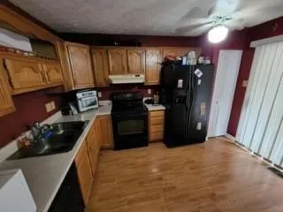 a kitchen with stainless steel appliances granite countertop a refrigerator stove and sink