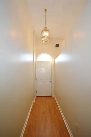a view of a hallway with wooden floor