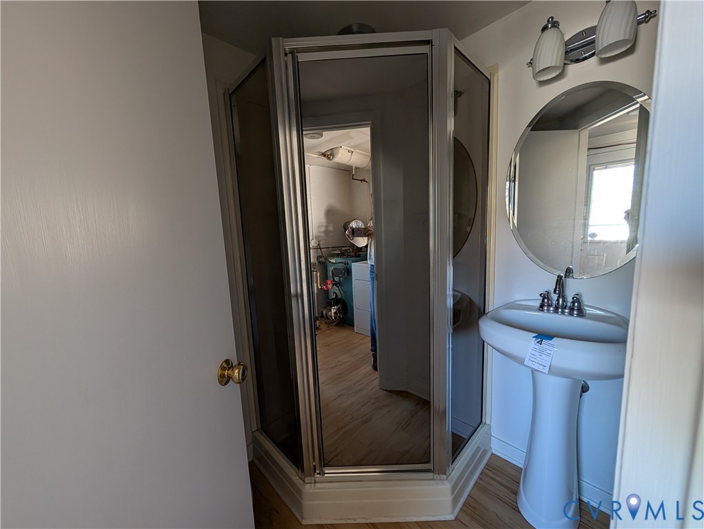 8216 Ireton Road Henrico, VA 23228 - Photo 12 of 16 a bathroom with a mirror sink and vanity