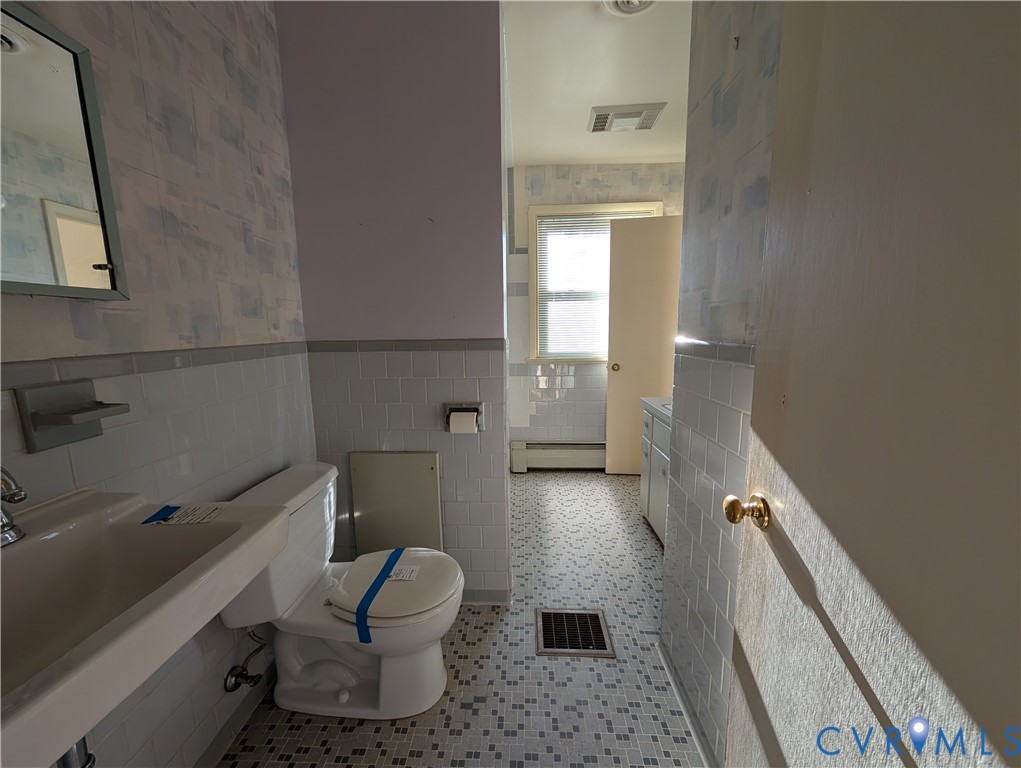 8216 Ireton Road Henrico, VA 23228 - Photo 13 of 16 a bathroom with a sink and mirror