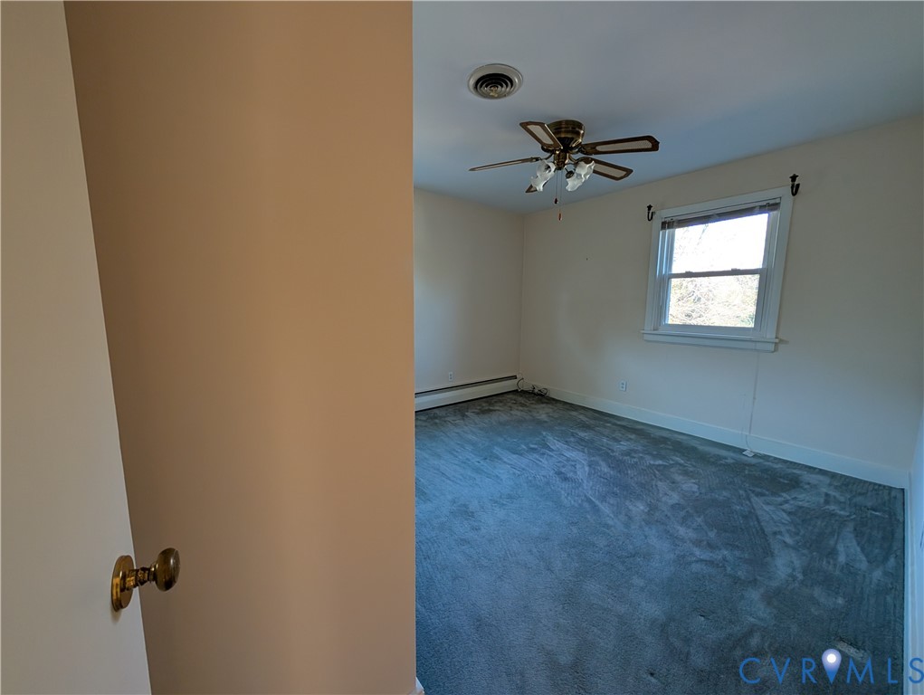 8216 Ireton Road Henrico, VA 23228 - Photo 15 of 16 an empty room with a window and a fan