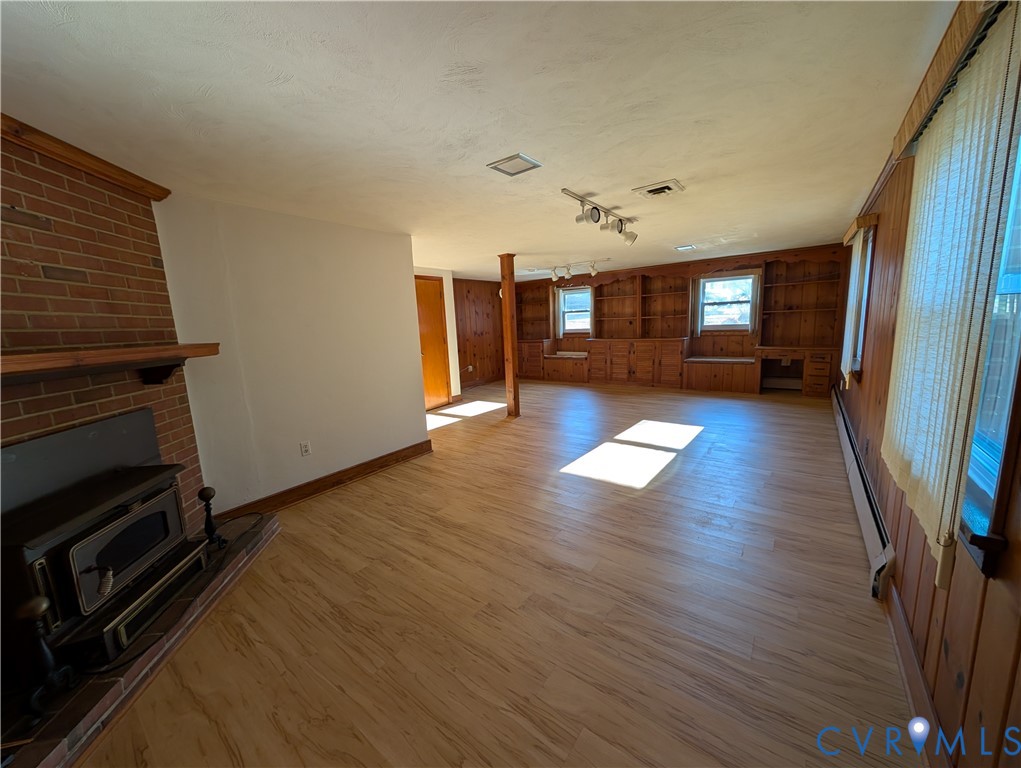 8216 Ireton Road Henrico, VA 23228 - Photo 10 of 16 an empty room with wooden floor and fireplace