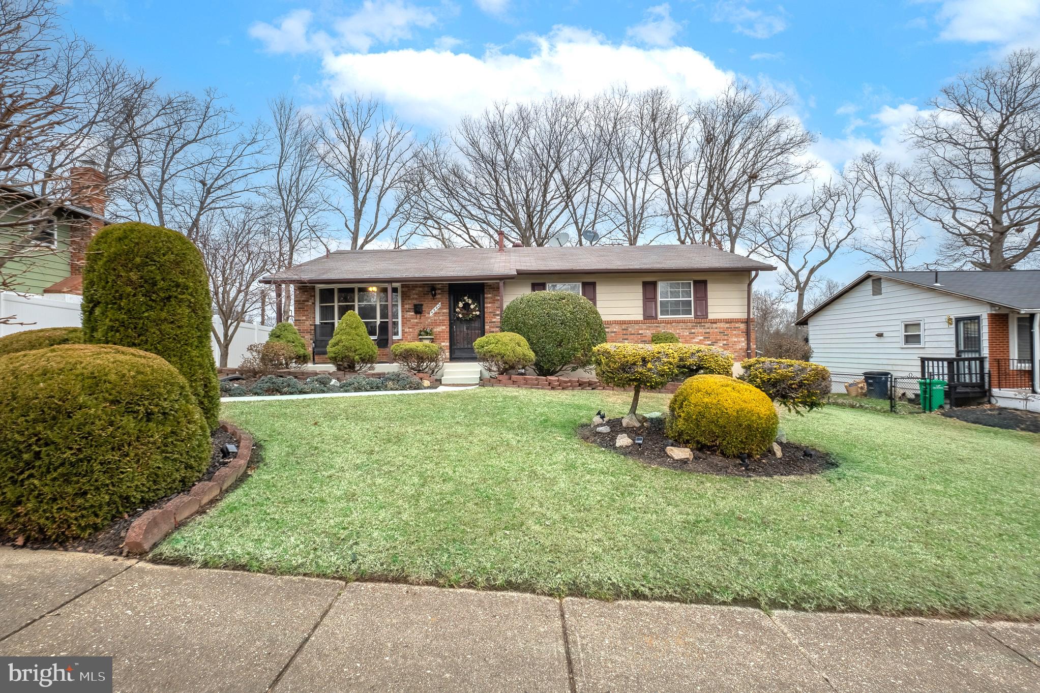a view of a house with a backyard and a tree