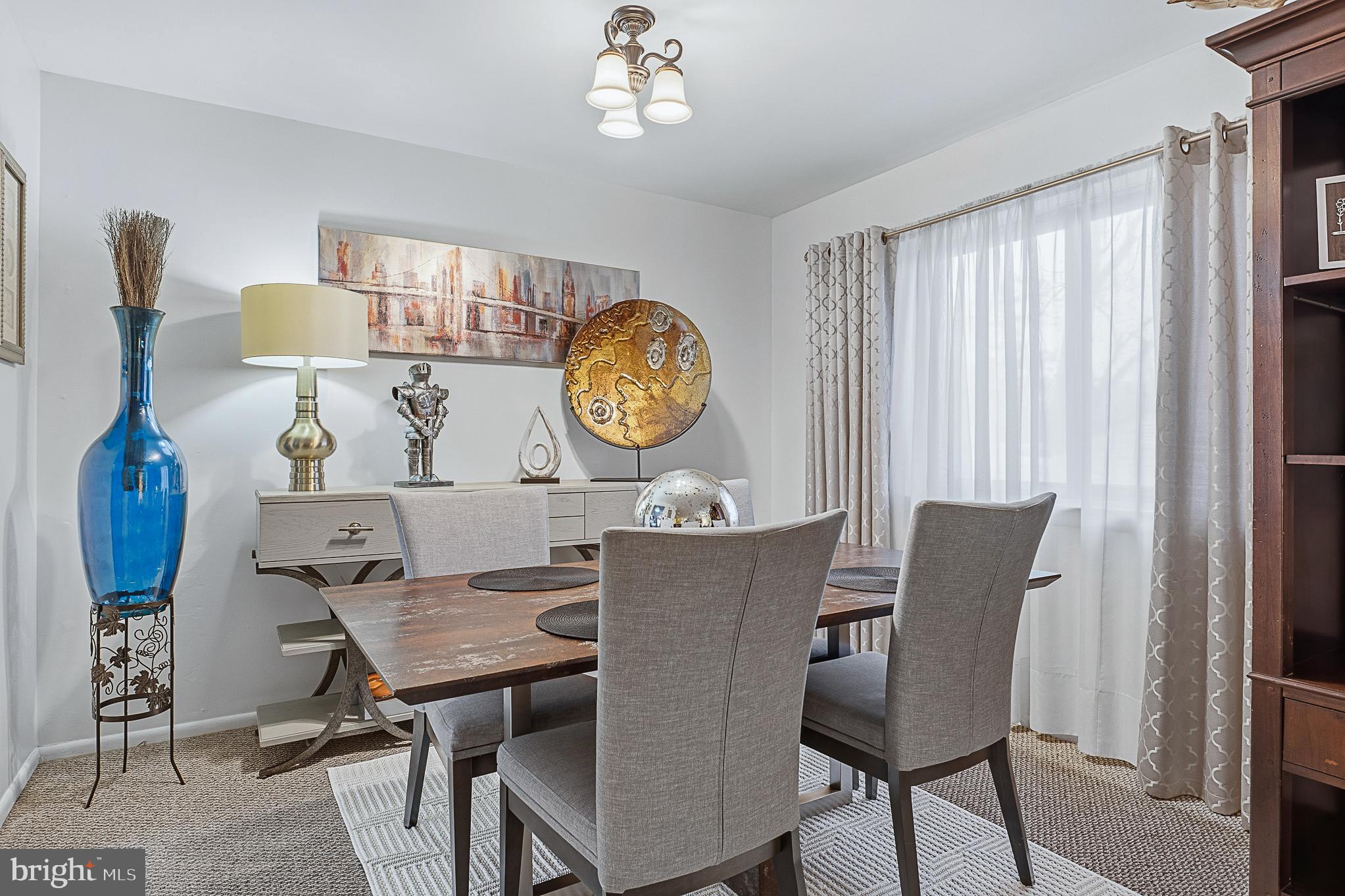 4542 Kinmount Road Lanham, MD 20706 - Photo 14 of 70 a view of a dining room with furniture and a chandelier