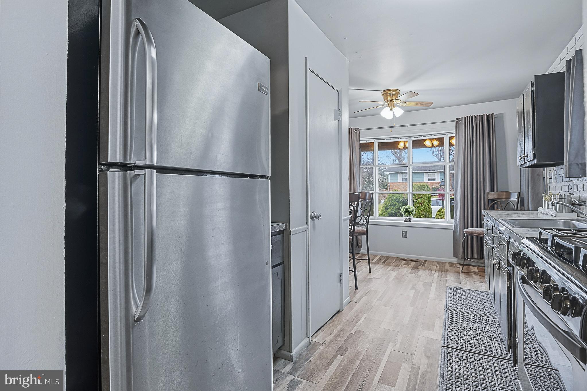 4542 Kinmount Road Lanham, MD 20706 - Photo 20 of 70 a kitchen with stainless steel appliances a refrigerator and a stove top oven