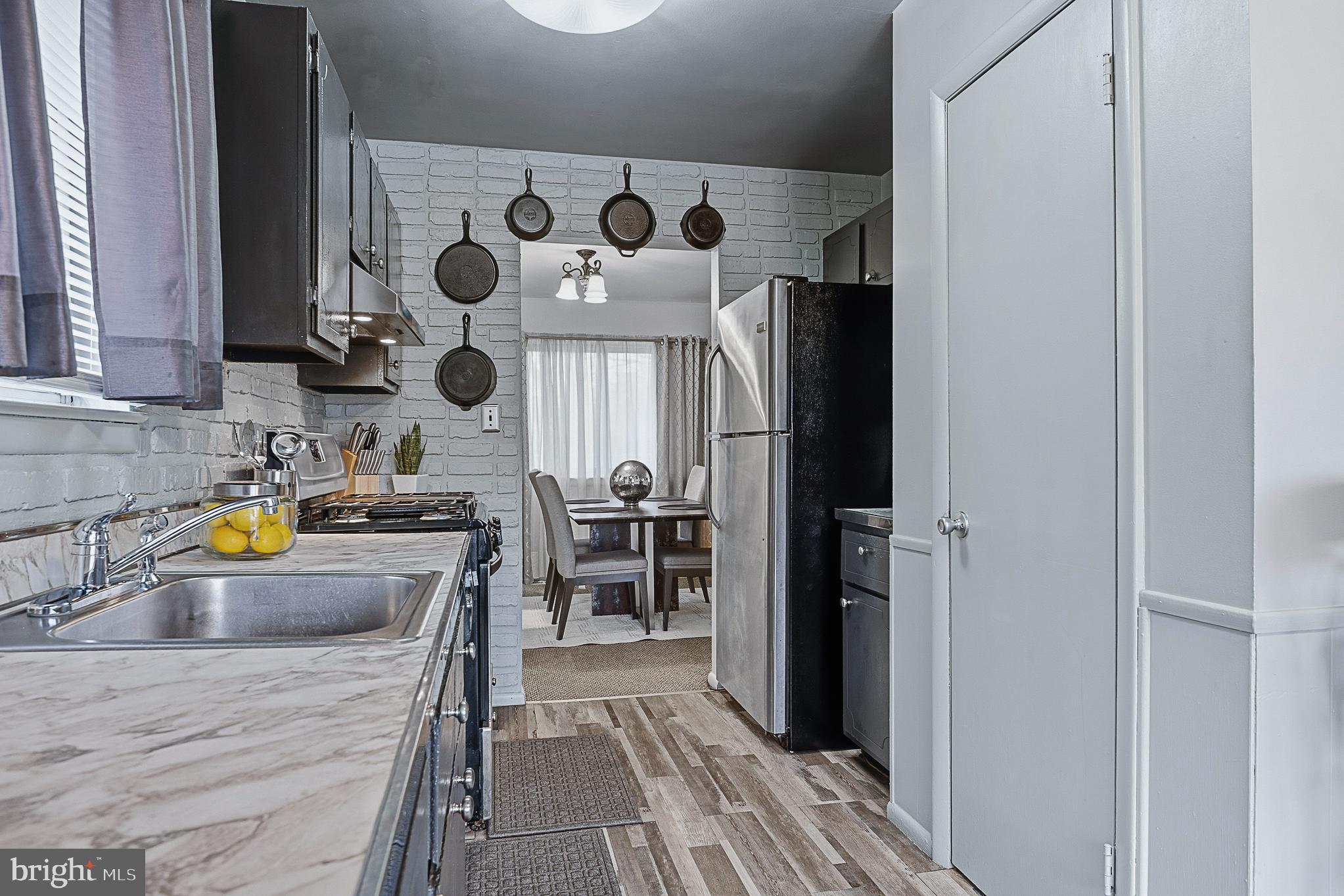 4542 Kinmount Road Lanham, MD 20706 - Photo 21 of 70 a kitchen with a refrigerator and a sink
