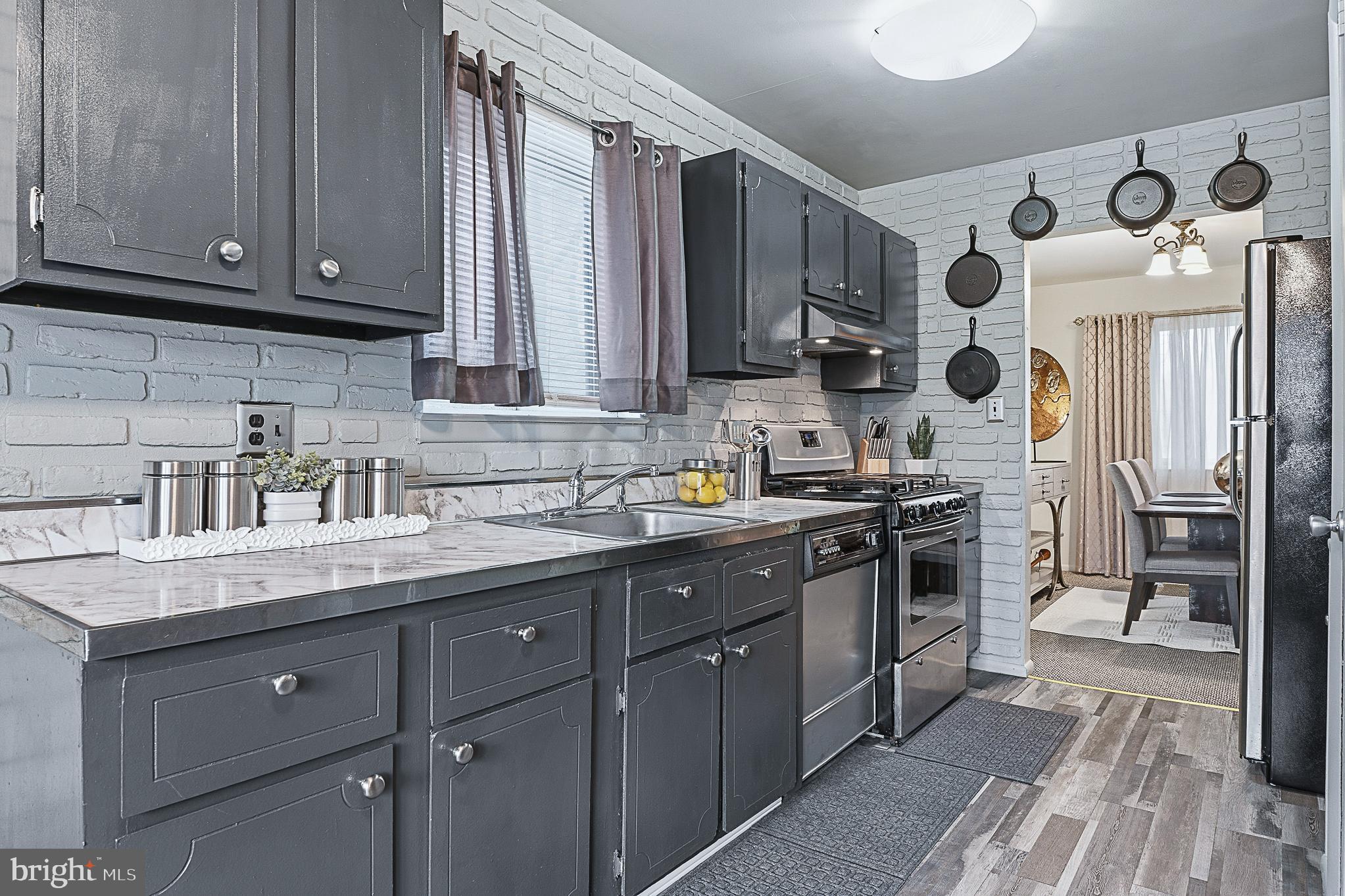 4542 Kinmount Road Lanham, MD 20706 - Photo 22 of 70 a kitchen with stainless steel appliances granite countertop a sink a stove and cabinets