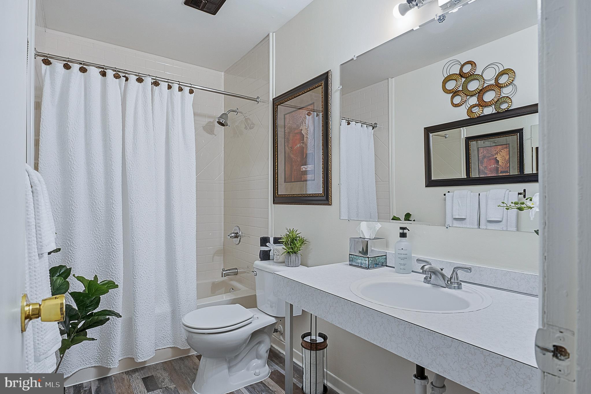 4542 Kinmount Road Lanham, MD 20706 - Photo 29 of 70 a bathroom with a sink a mirror and a toilet
