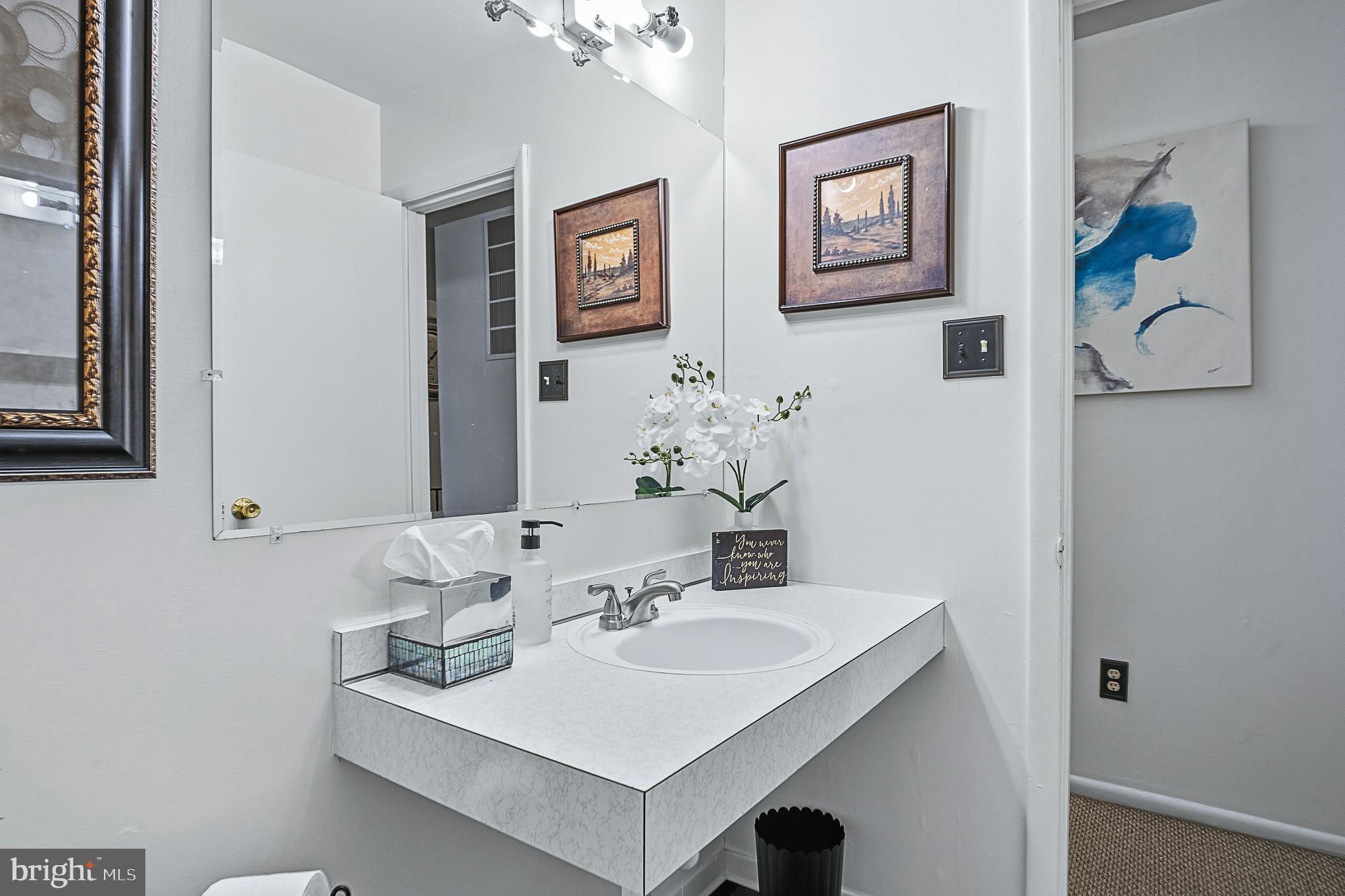 4542 Kinmount Road Lanham, MD 20706 - Photo 30 of 70 a bathroom with a sink and a mirror