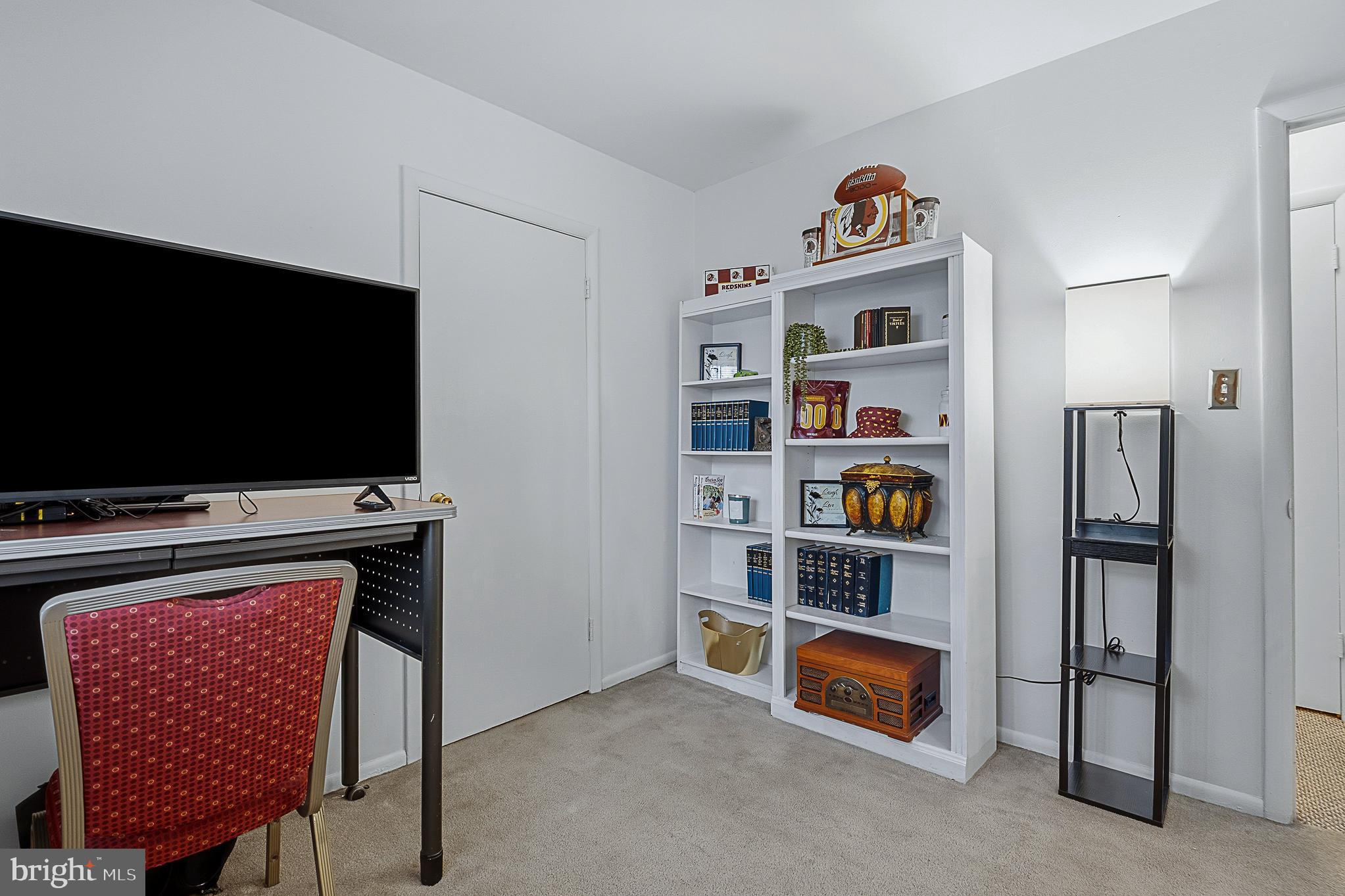 4542 Kinmount Road Lanham, MD 20706 - Photo 32 of 70 a living room with furniture and a flat screen tv