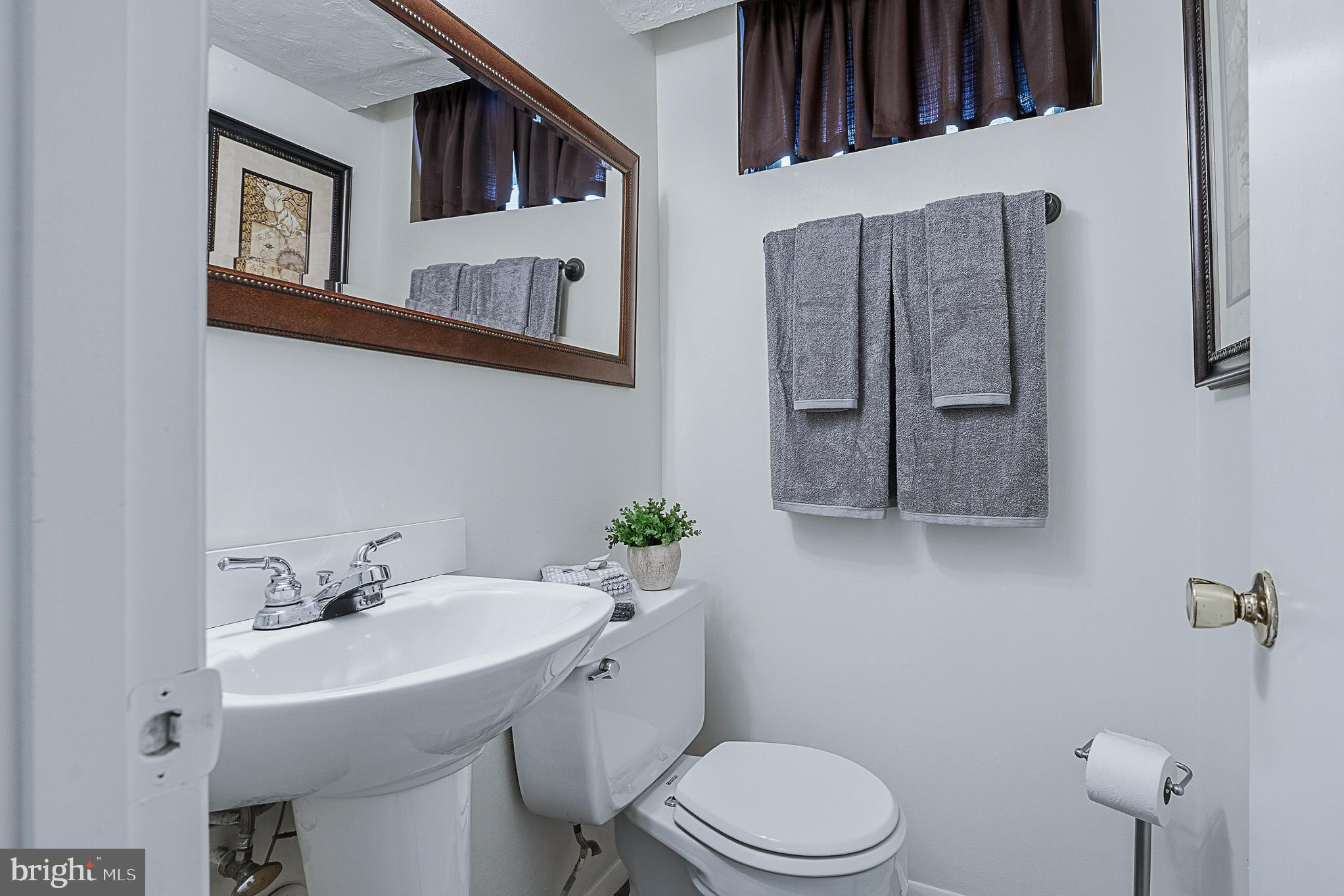 4542 Kinmount Road Lanham, MD 20706 - Photo 49 of 70 a bathroom with a sink toilet and a mirror